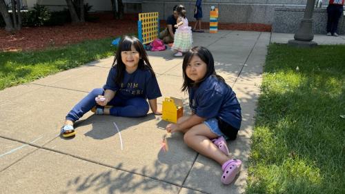 two-sisters-playing-chalk